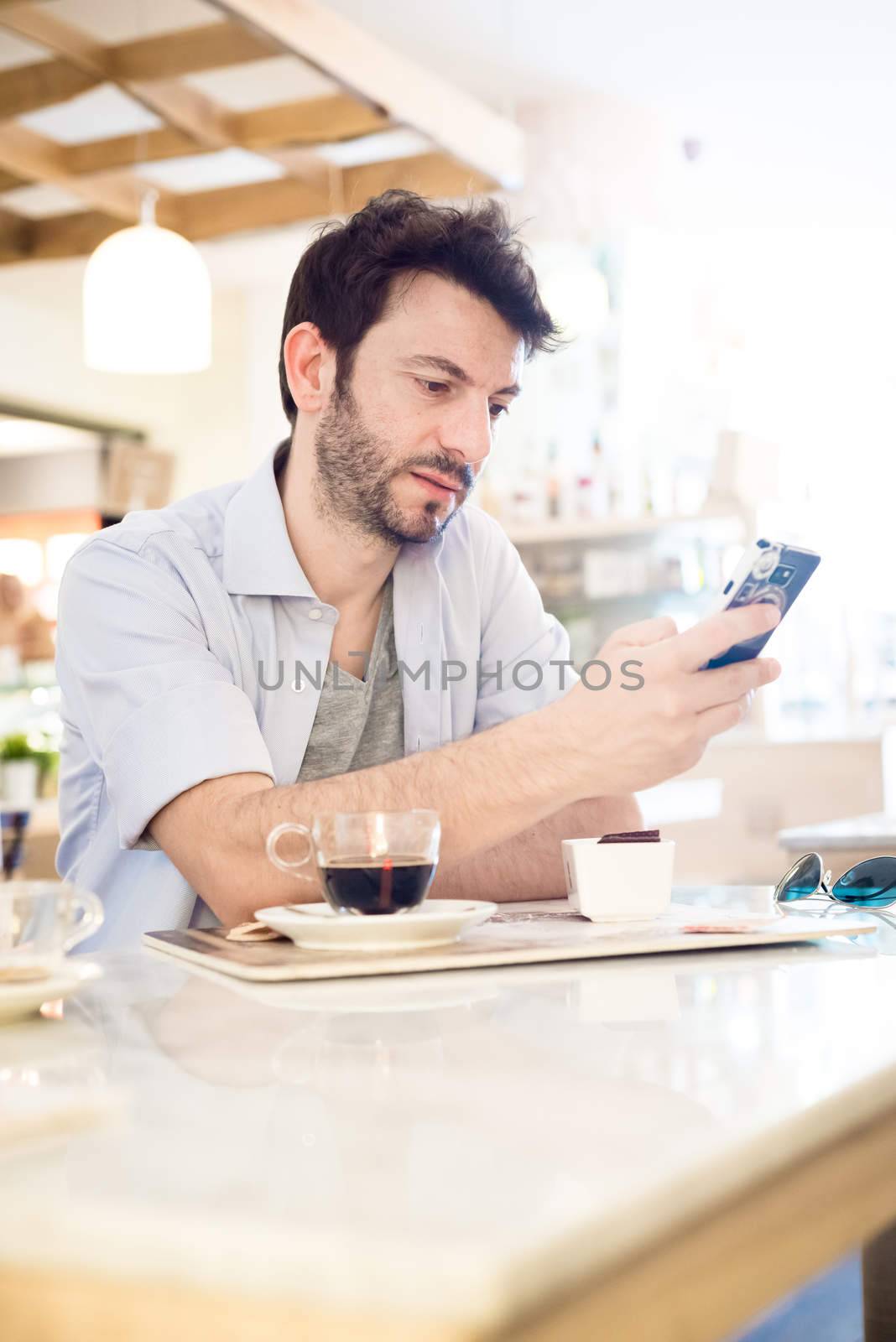 man at the bar on the phone in the morning
