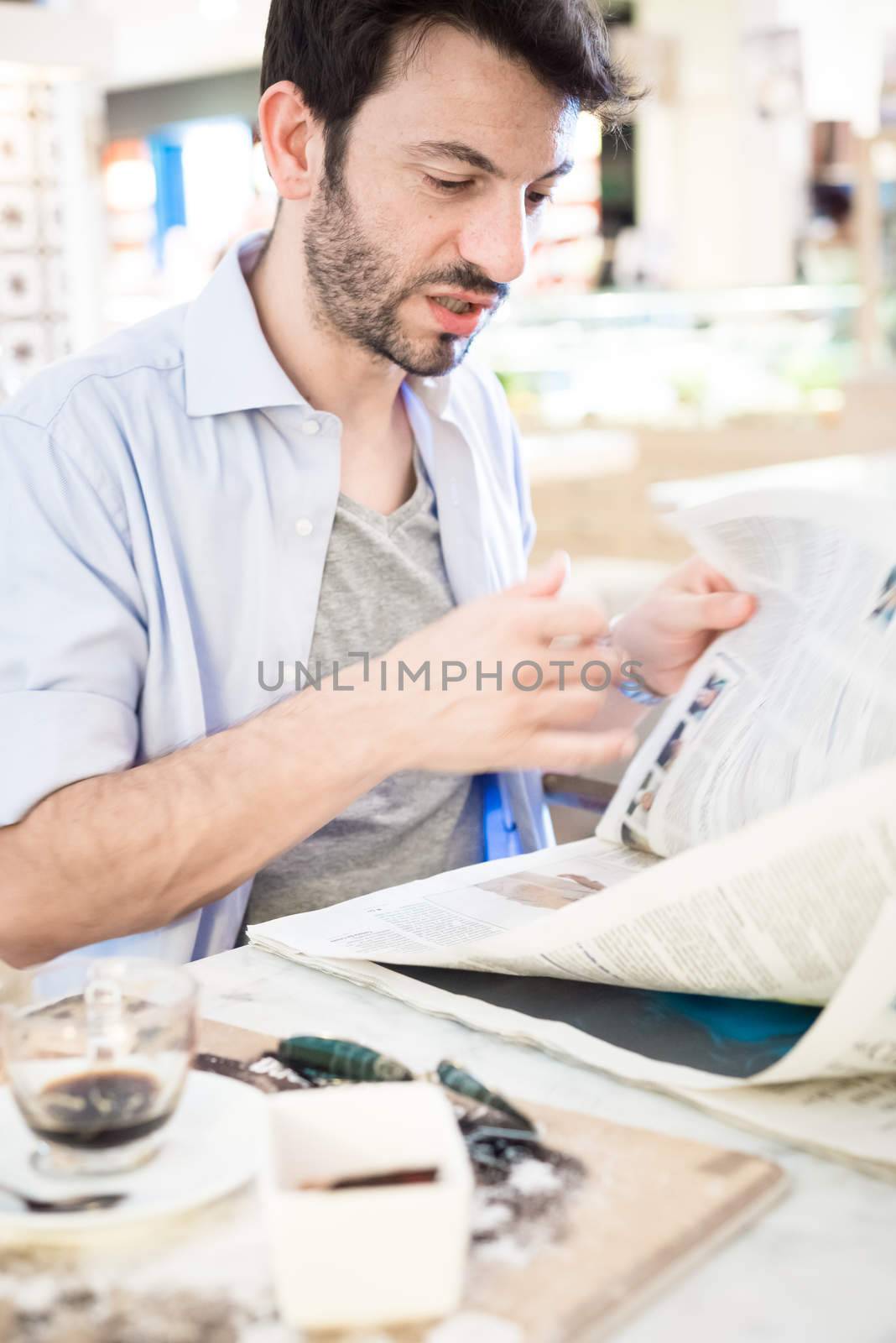 man at the bar reading newspaper by peus