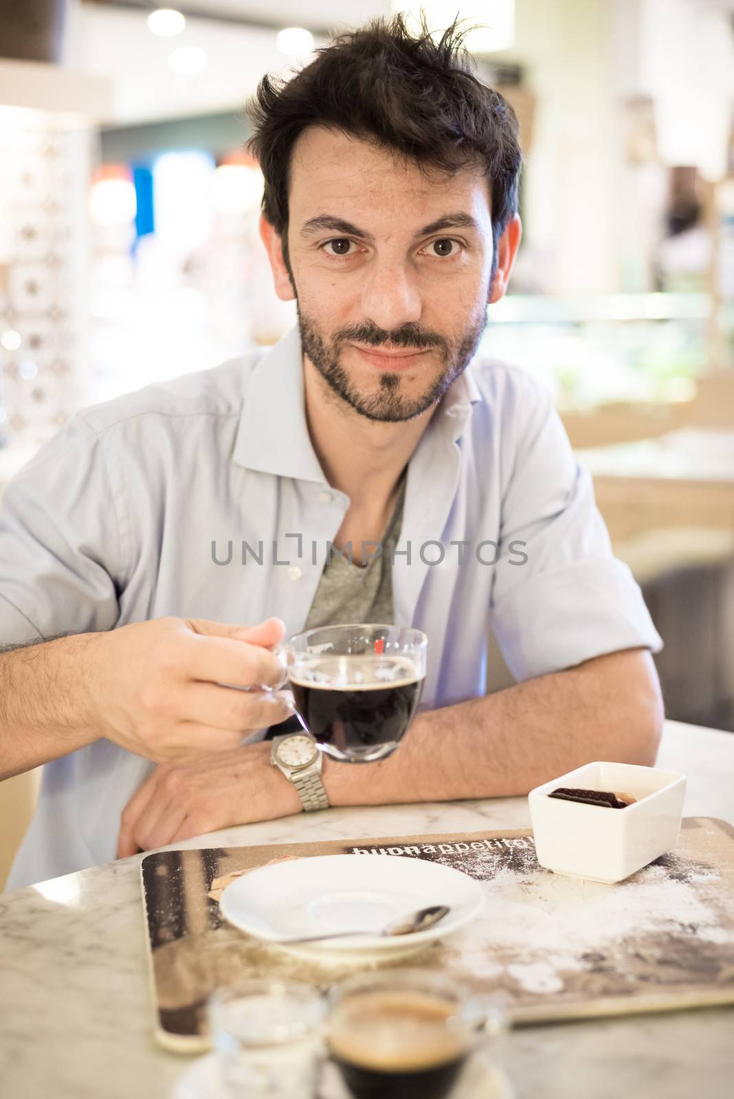 man at the bar drinking coffee in the morning