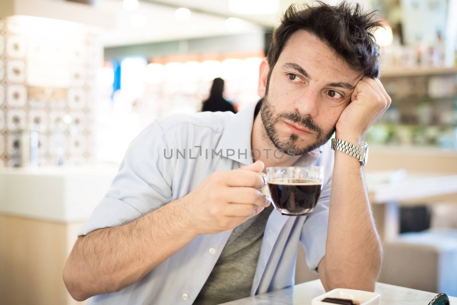 man at the bar drinking coffee in the morning
