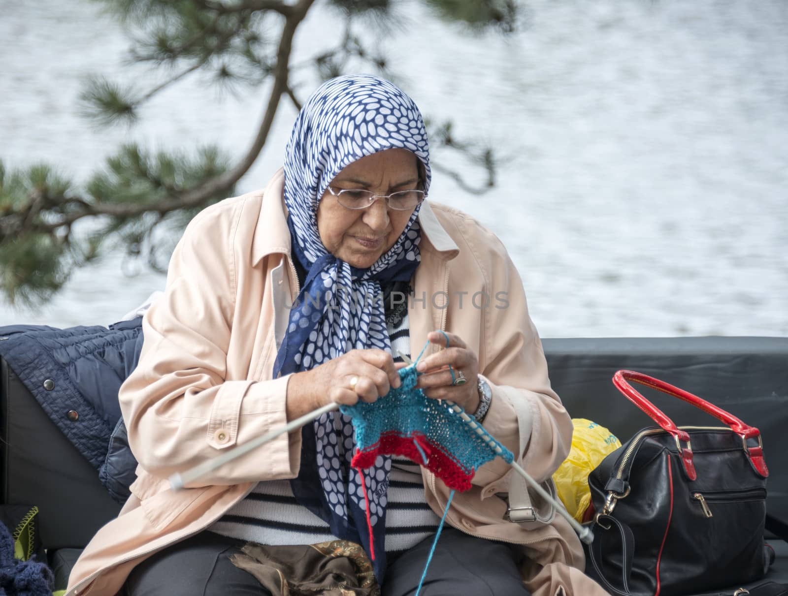 HELLEVOETSLUIS,HOLLAND - JUNE 29:Unidentified woman knitting on a sofa outside,on June 29,2013 in Hellevoetsluis,Holland.This days is once a year to introduce art and culture