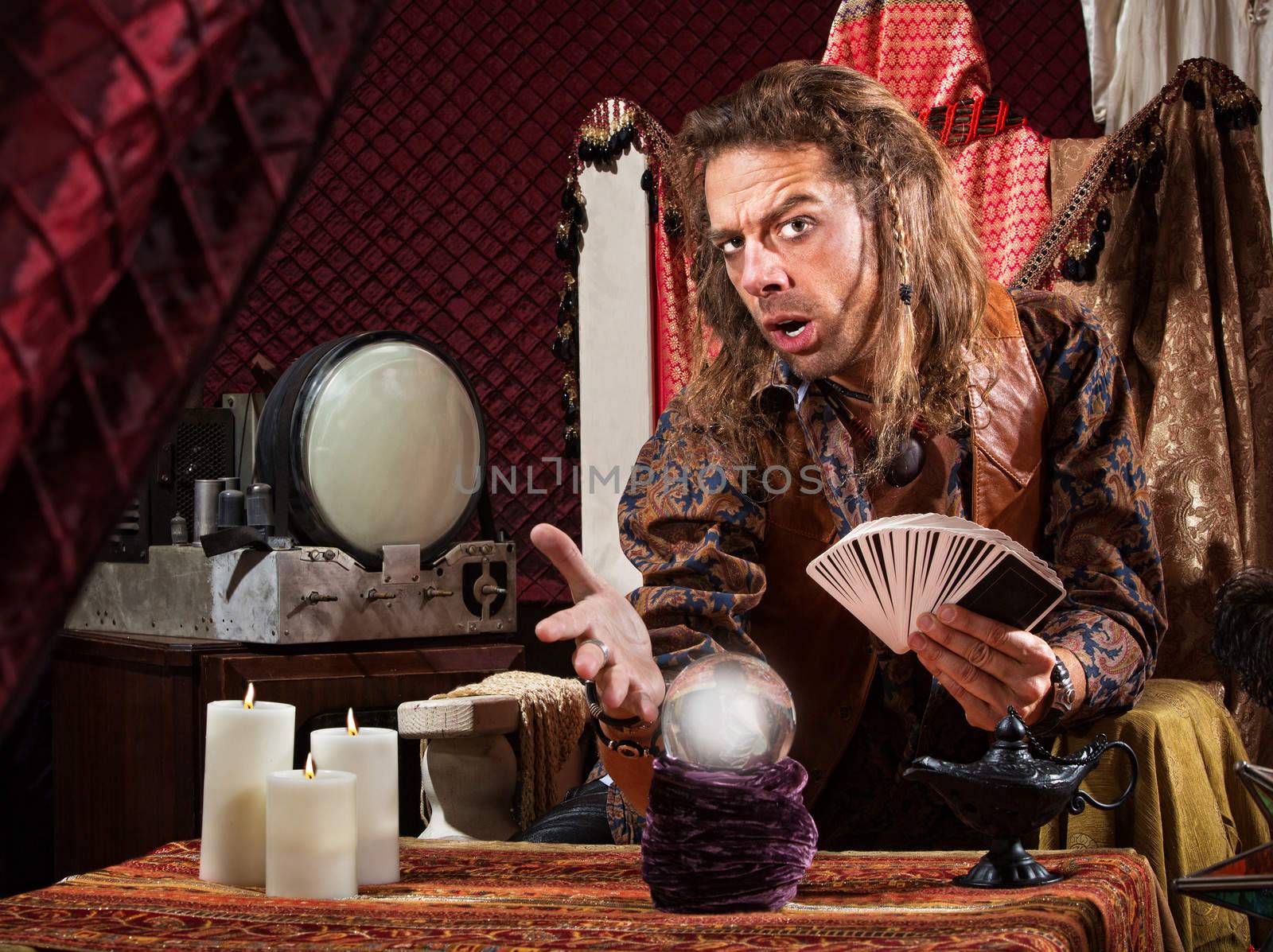 Enticing man with tarot cards and crystal ball