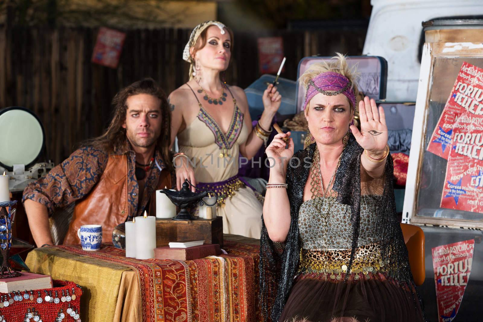 Blond female fortune teller displaying an evil eye in her palm