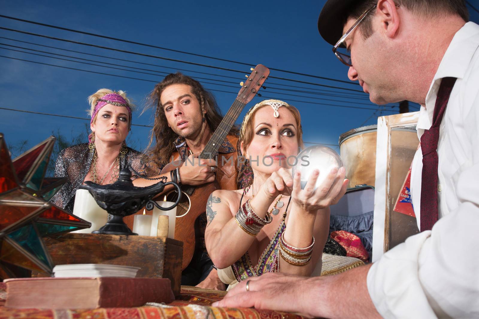 Beautiful fortune teller with glowing crystal ball with customer