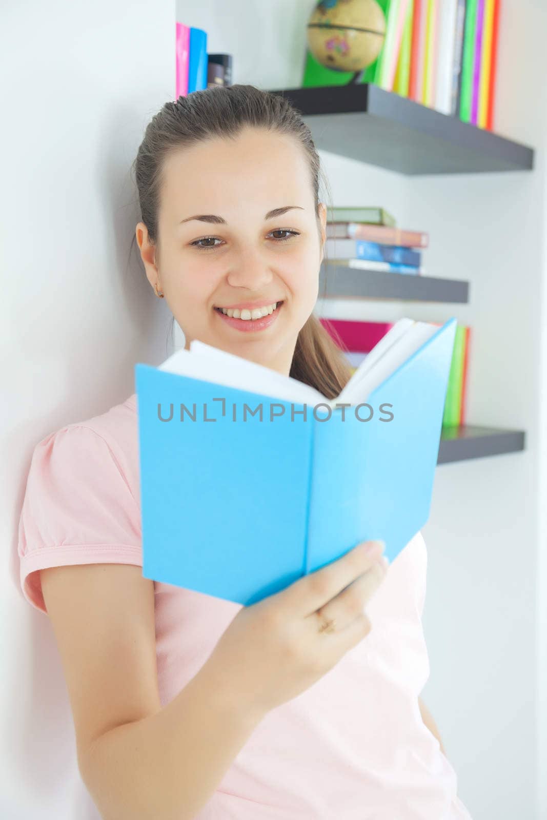 Young attractive lady sitting with a book