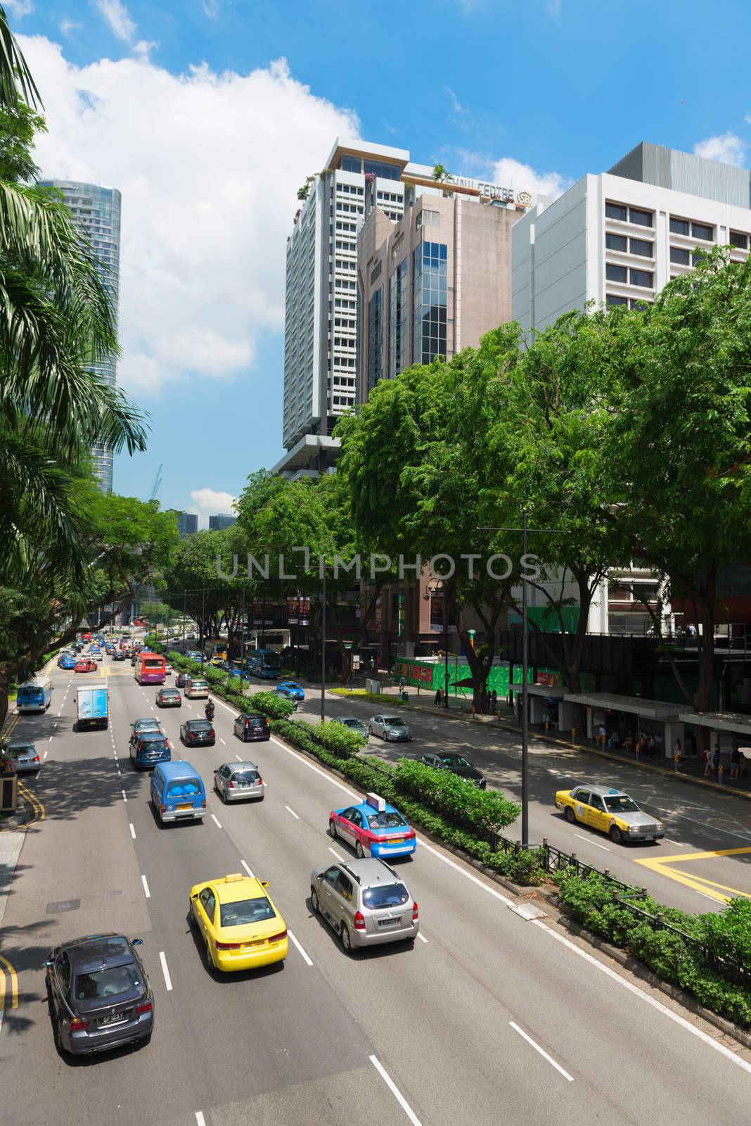 SINGAPORE - JUN 1: Cars drive along famous Orchard road on Jun 1, 2013 in Singapore. This 2.2 kilometer street is the retail hub of the city. It is a major tourist attraction as shopping street.