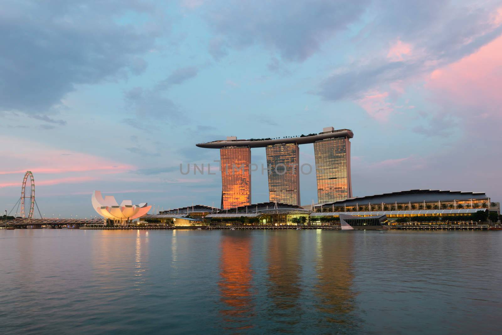 SINGAPORE - JUN 1: Marina Bay Sands complex and Singapore Flyer skyline on sunset on Jun 1, 2013 in Singapore. It is an integrated resort became a  symbol of modern Singapore.