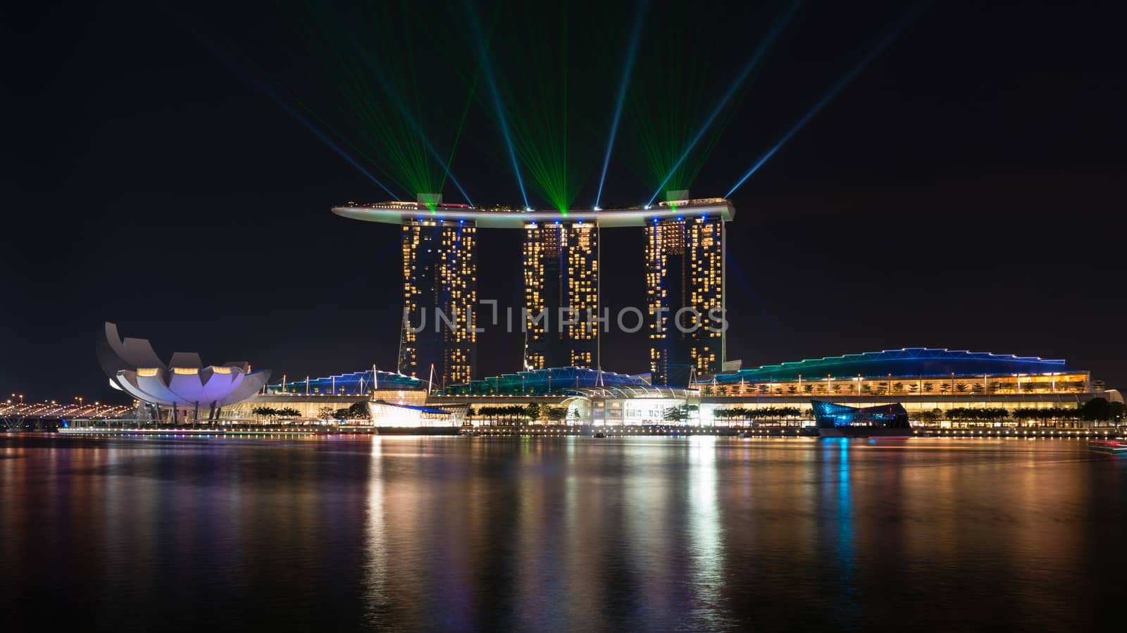 SINGAPORE - JUN 1: Laser show on Marina Bay Sands complex skyline at night on Jun 1, 2013 in Singapore. It is an integrated resort became a  symbol of modern Singapore.