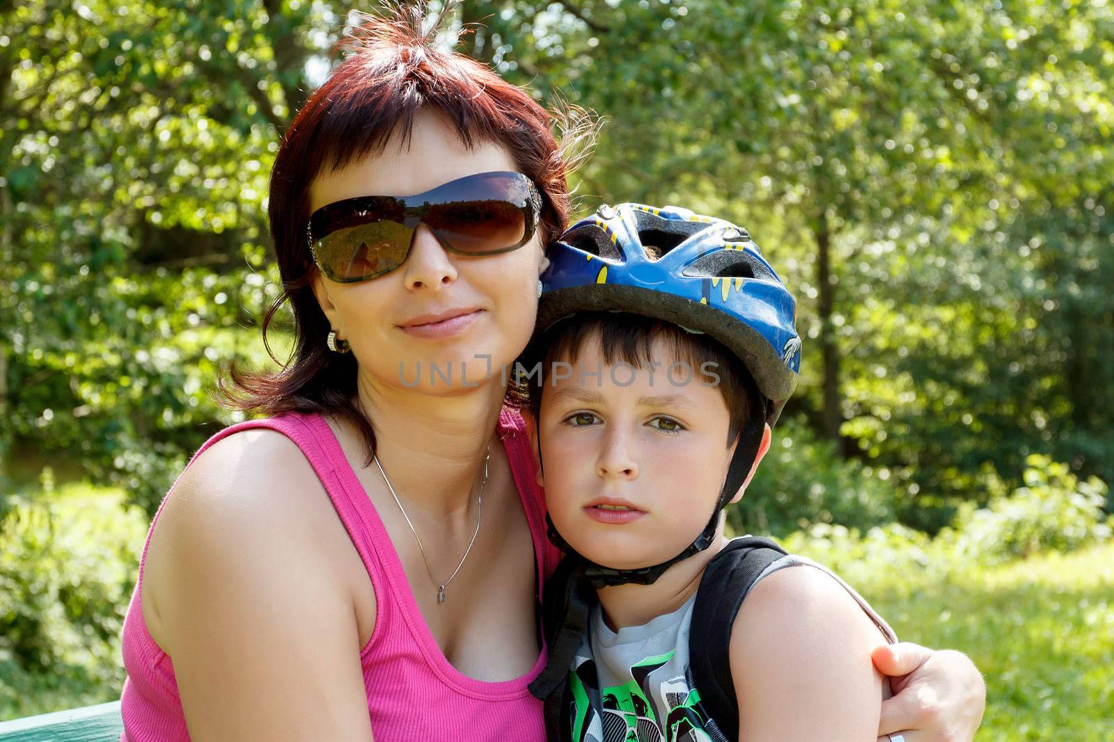 Mother and her son with bicycle helmet outdoor