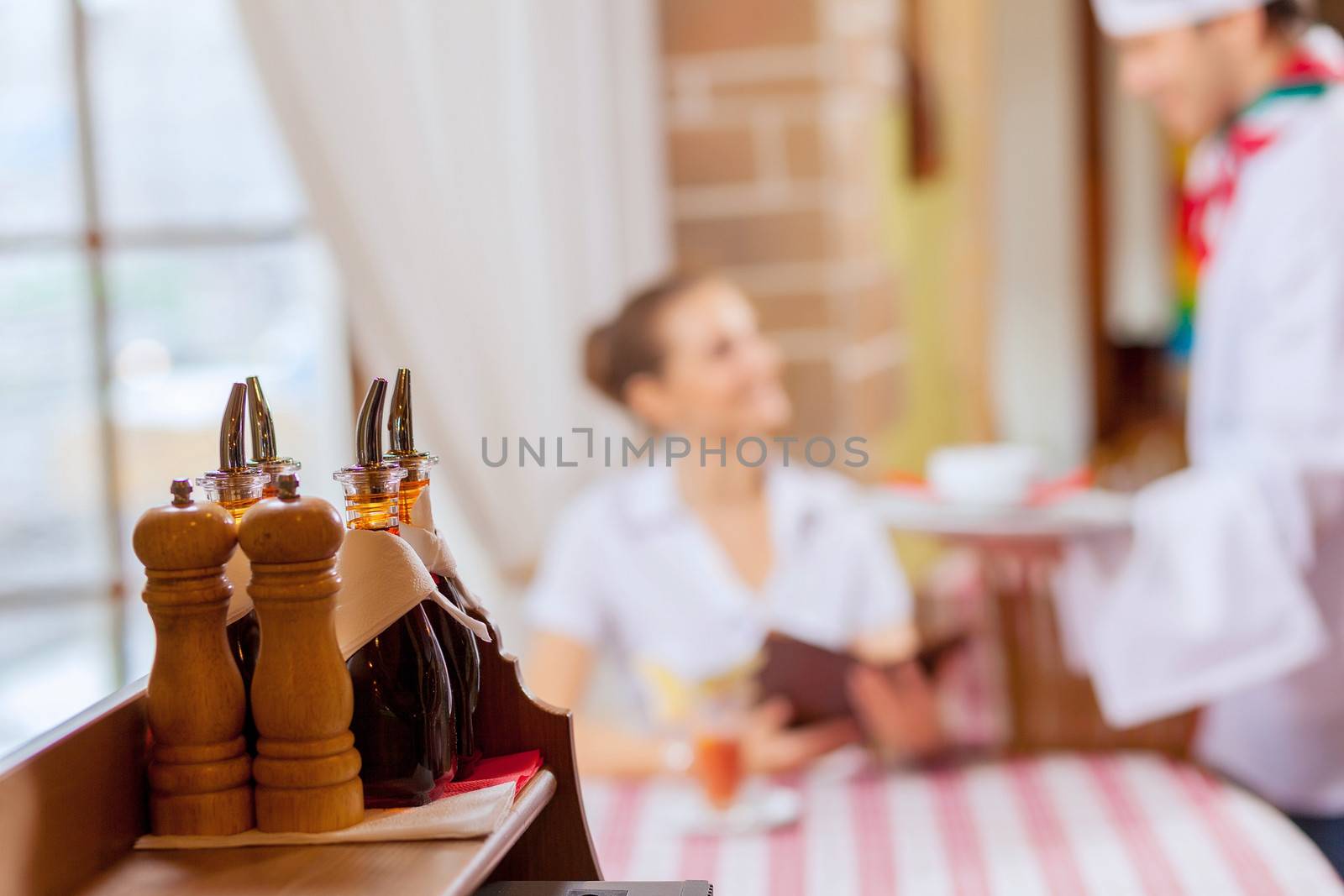 Young woman at restaurant sitting at table