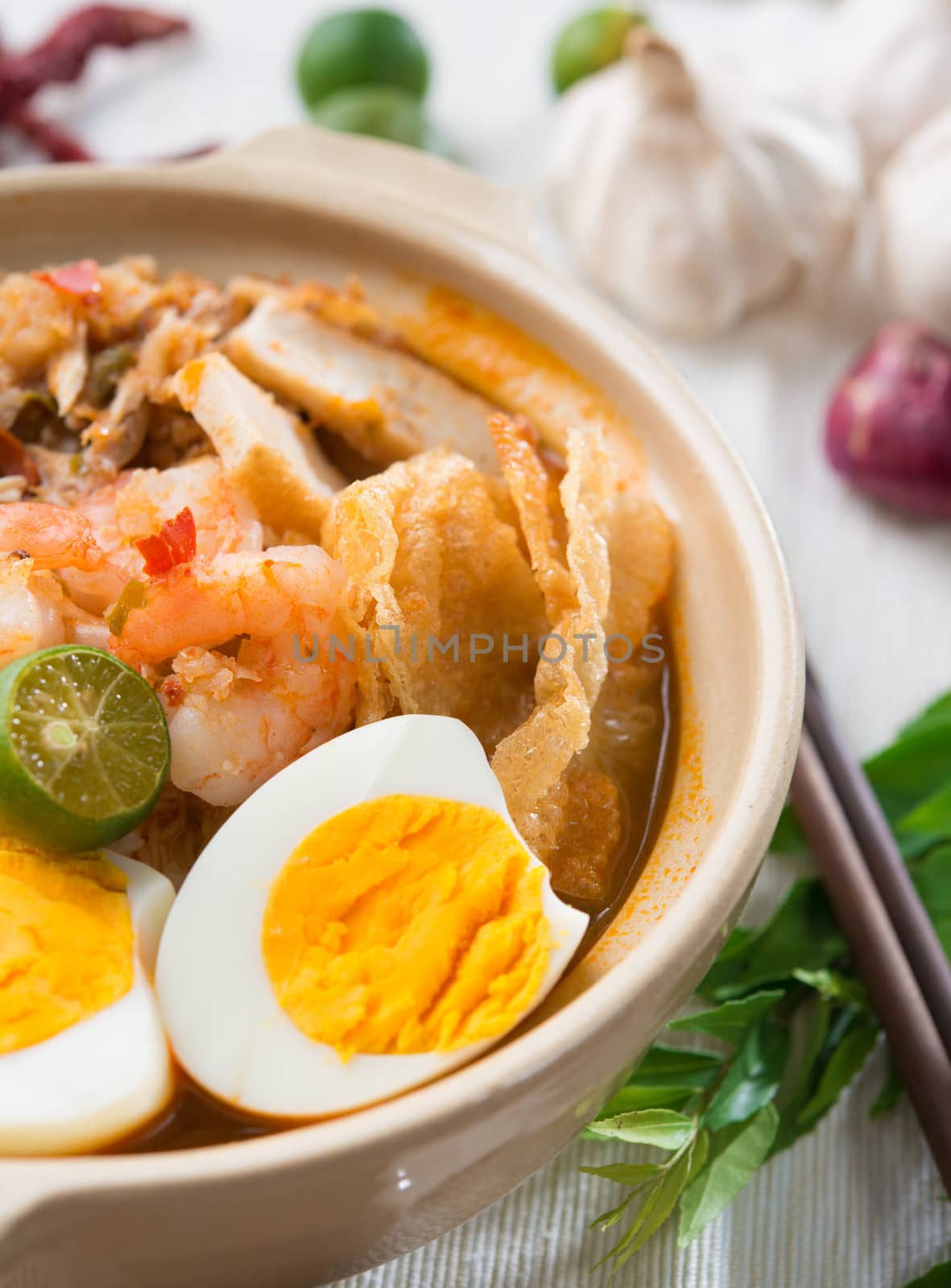 Prawn noodles or prawn mee. Famous Singapore food spicy fresh cooked har mee in clay pot with hot steam. Asian cuisine.
