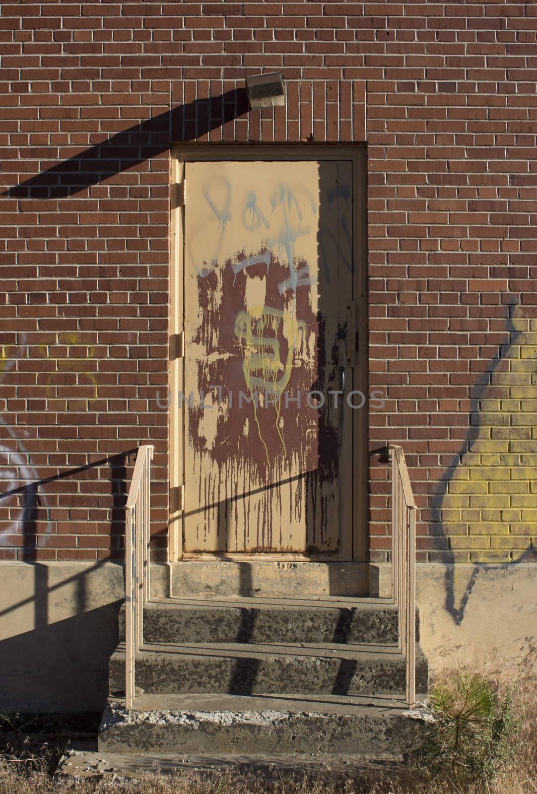 Old brick house door graffiti by jeremywhat