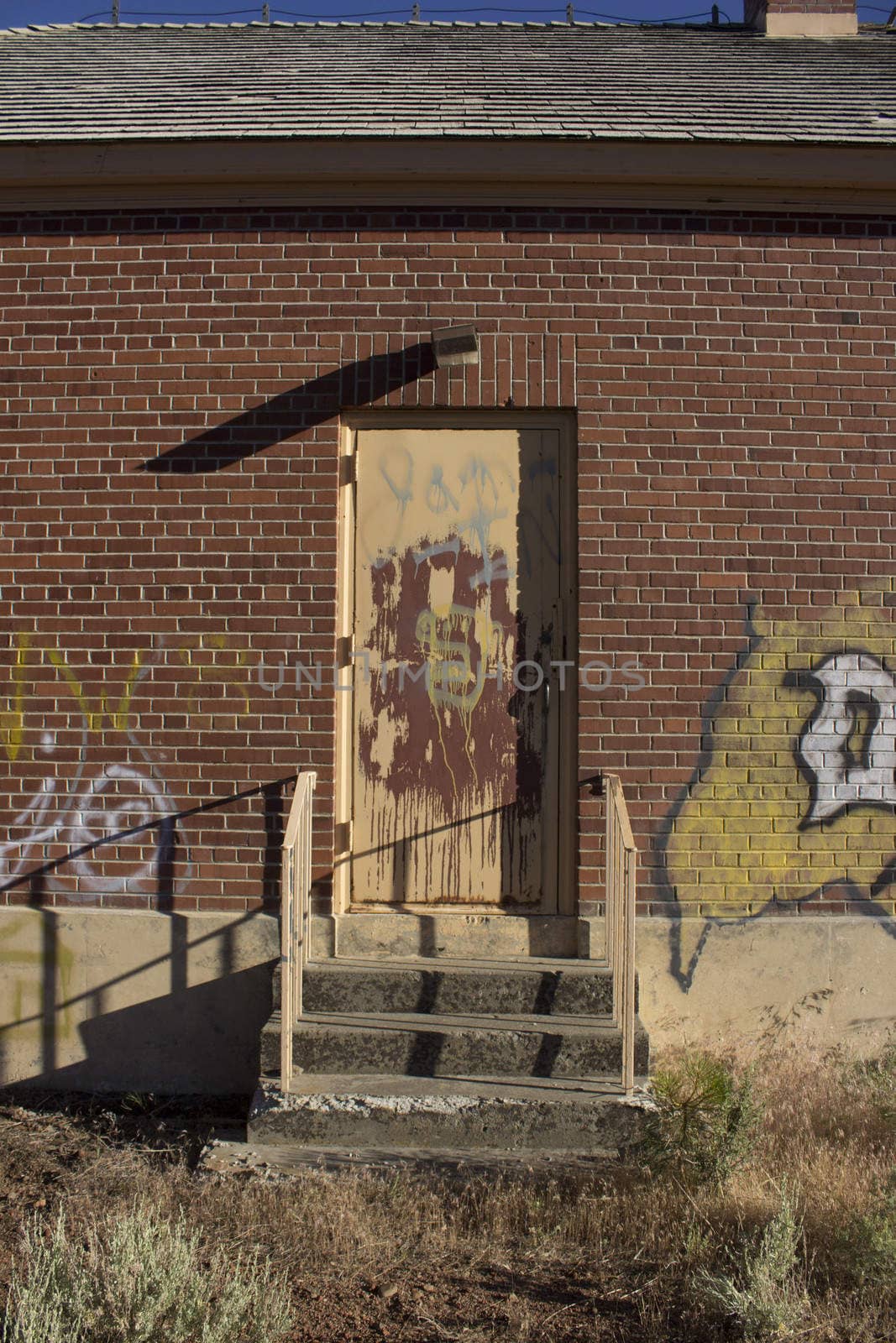 Old brick house door graffiti by jeremywhat