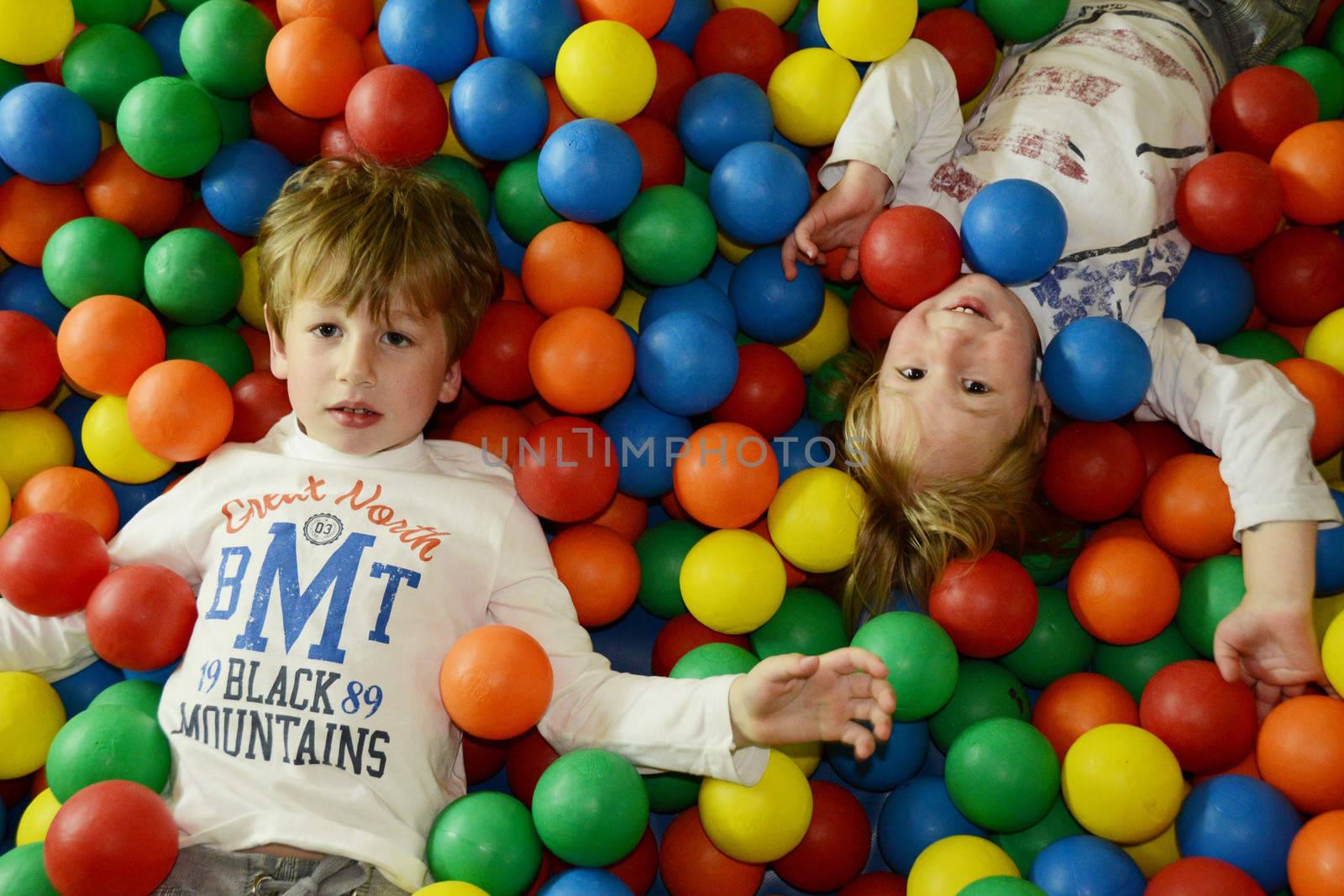 happy kids playing with colored balls by finta2609