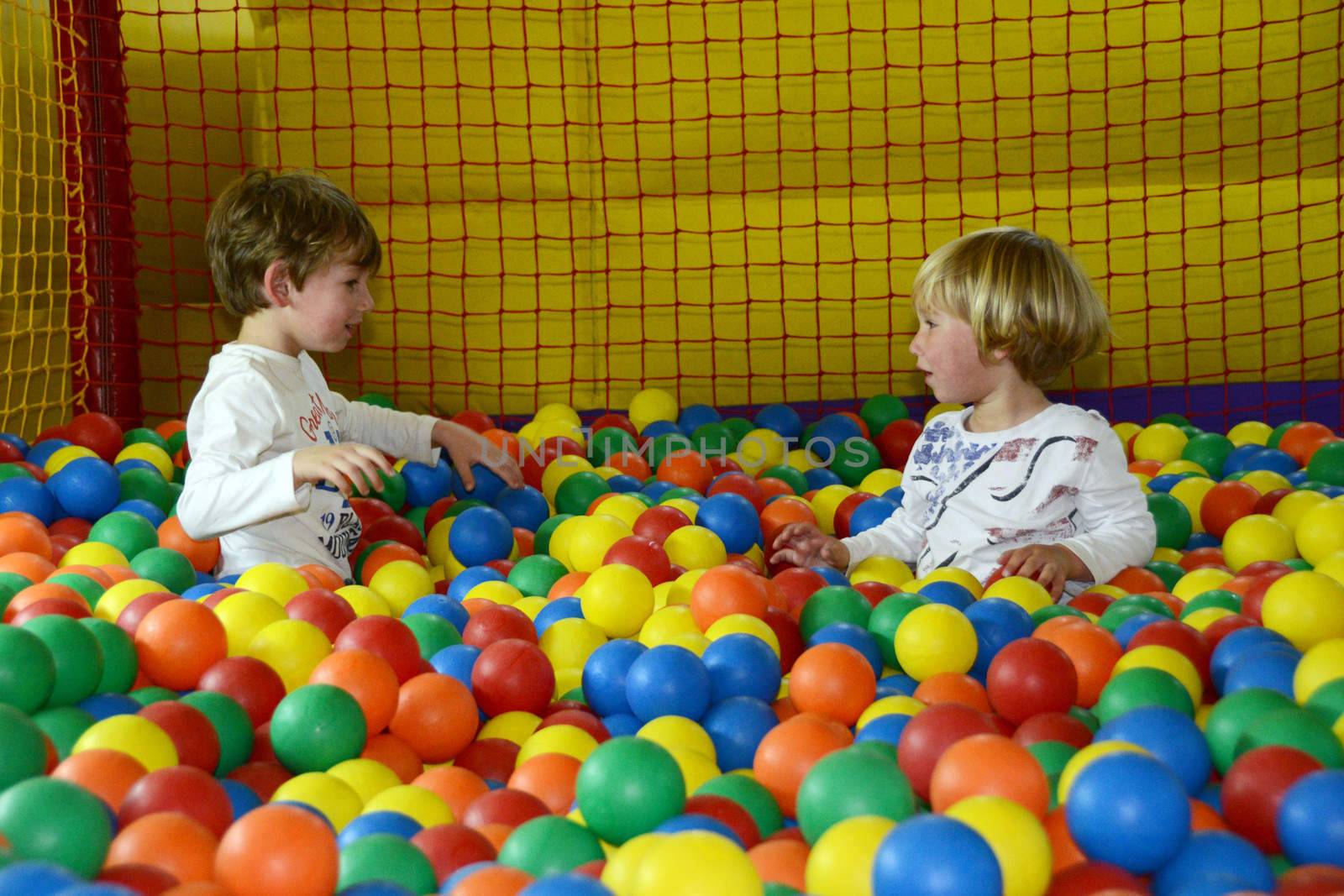 happy kids playing with colored balls by finta2609