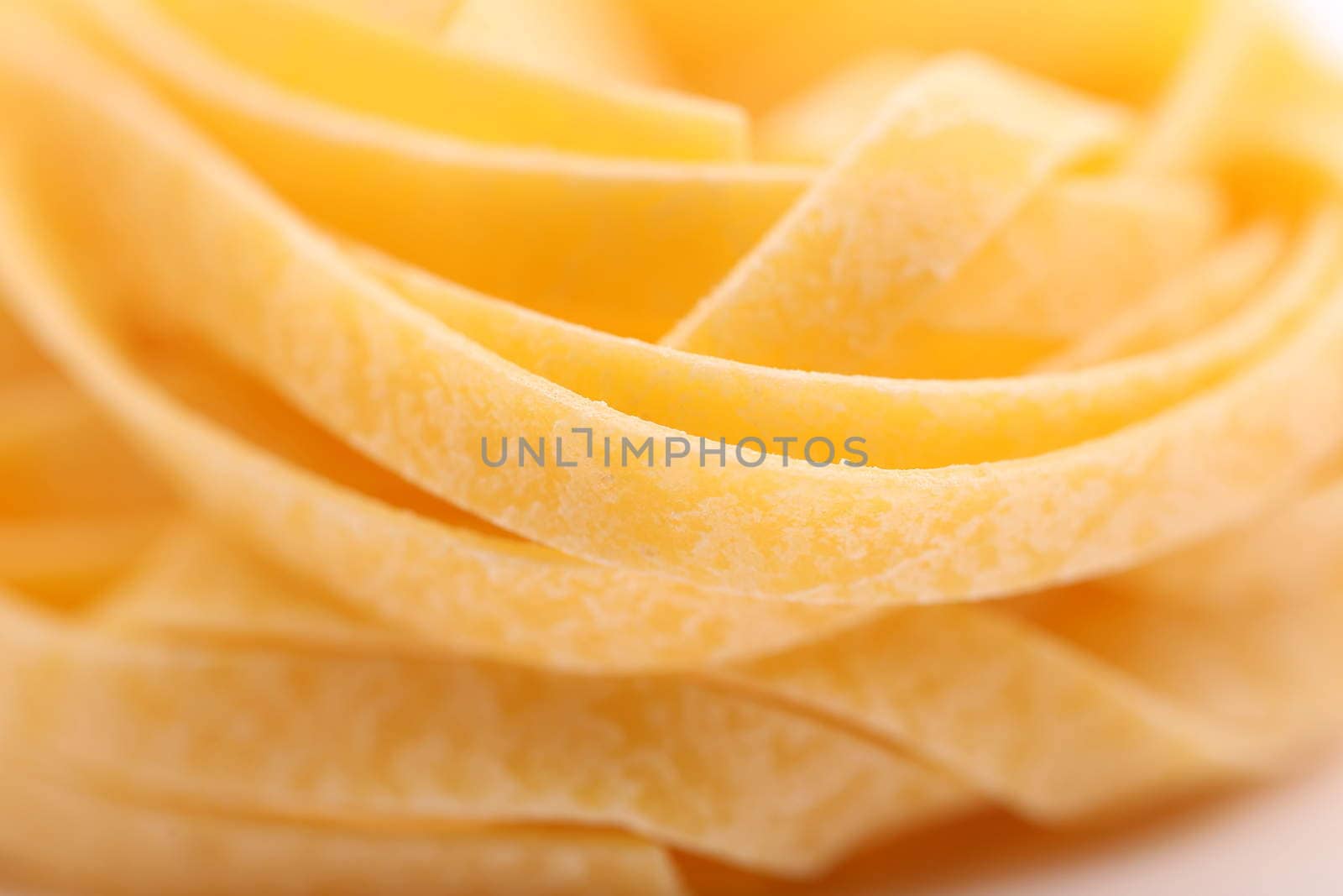 Yellow tagliatelle, close-up, background