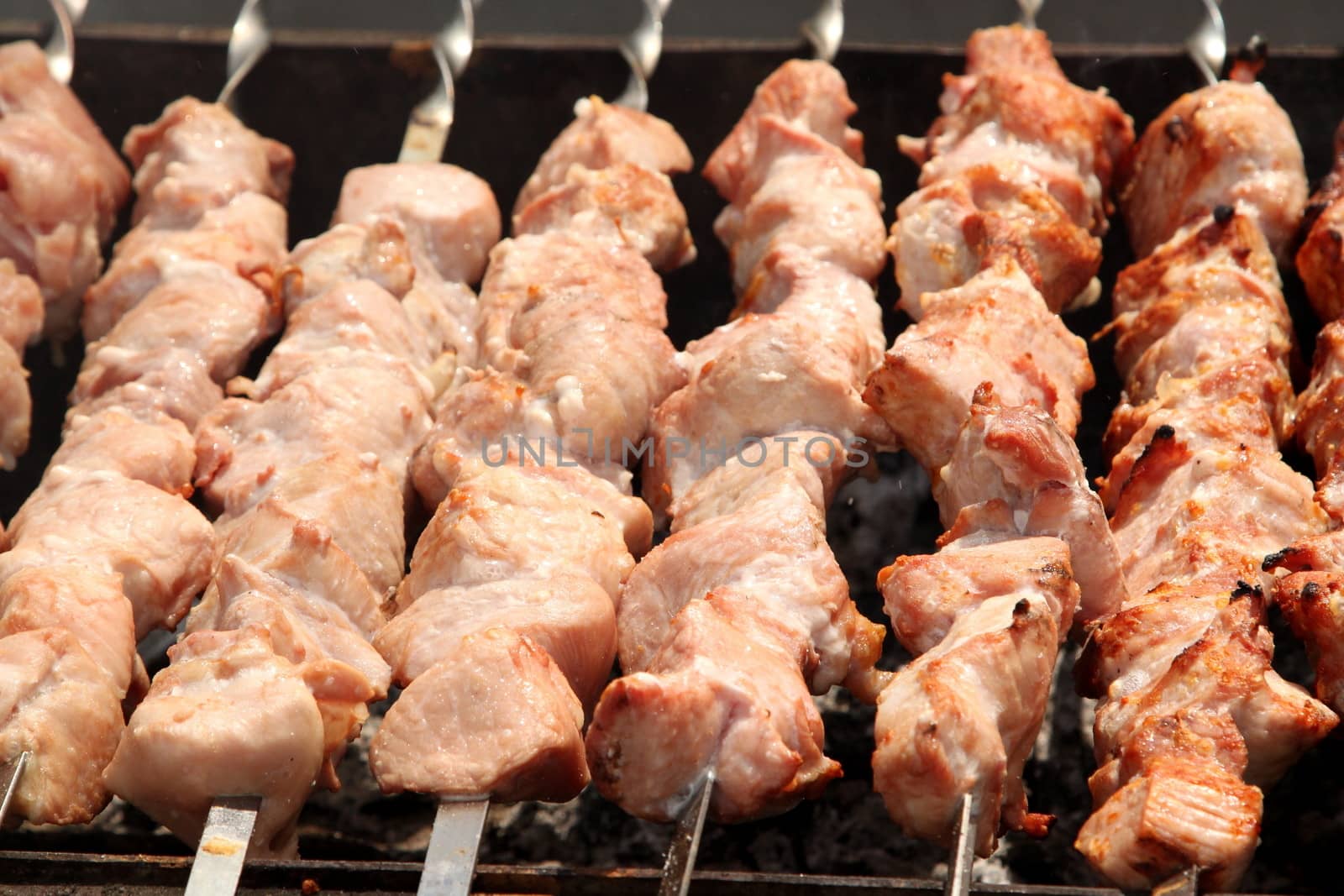 beef skewers cooked on the barbecue by indigolotos