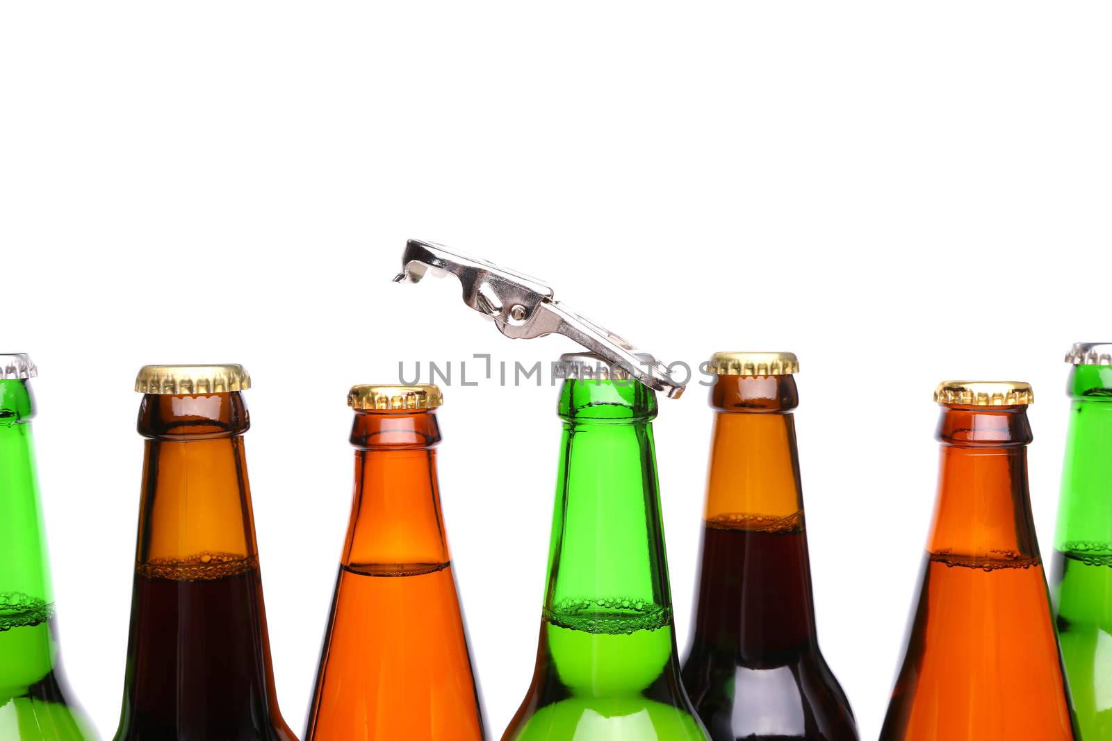 Top bottles of beer and a opener by indigolotos