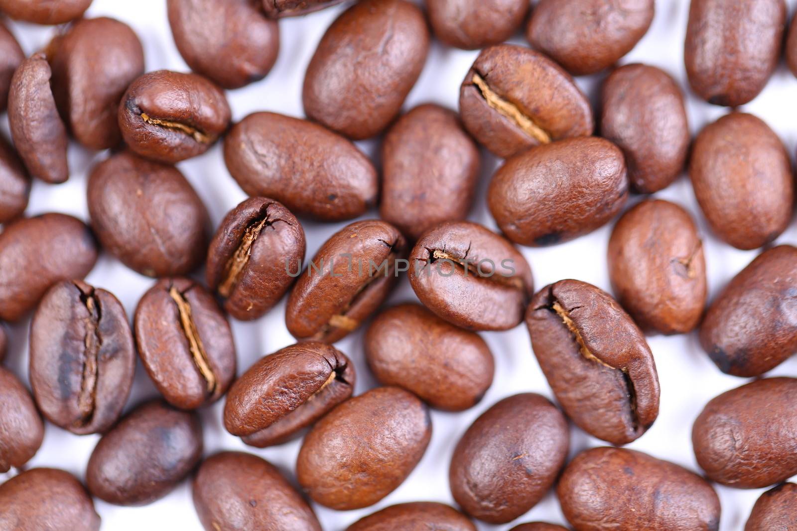 Coffee beans close-up on the white background.