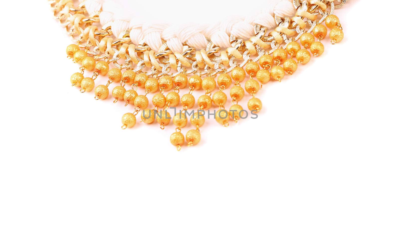 necklace of gold pearls on a white bacground