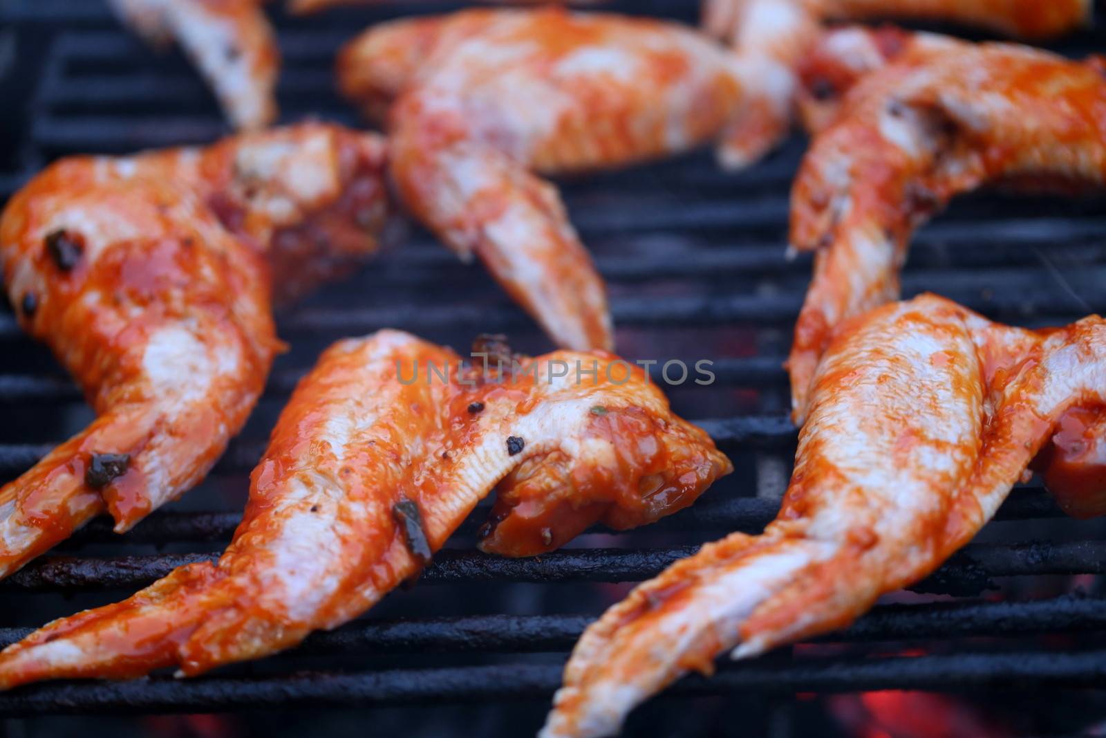 chicken wings on smoking grill in the garden