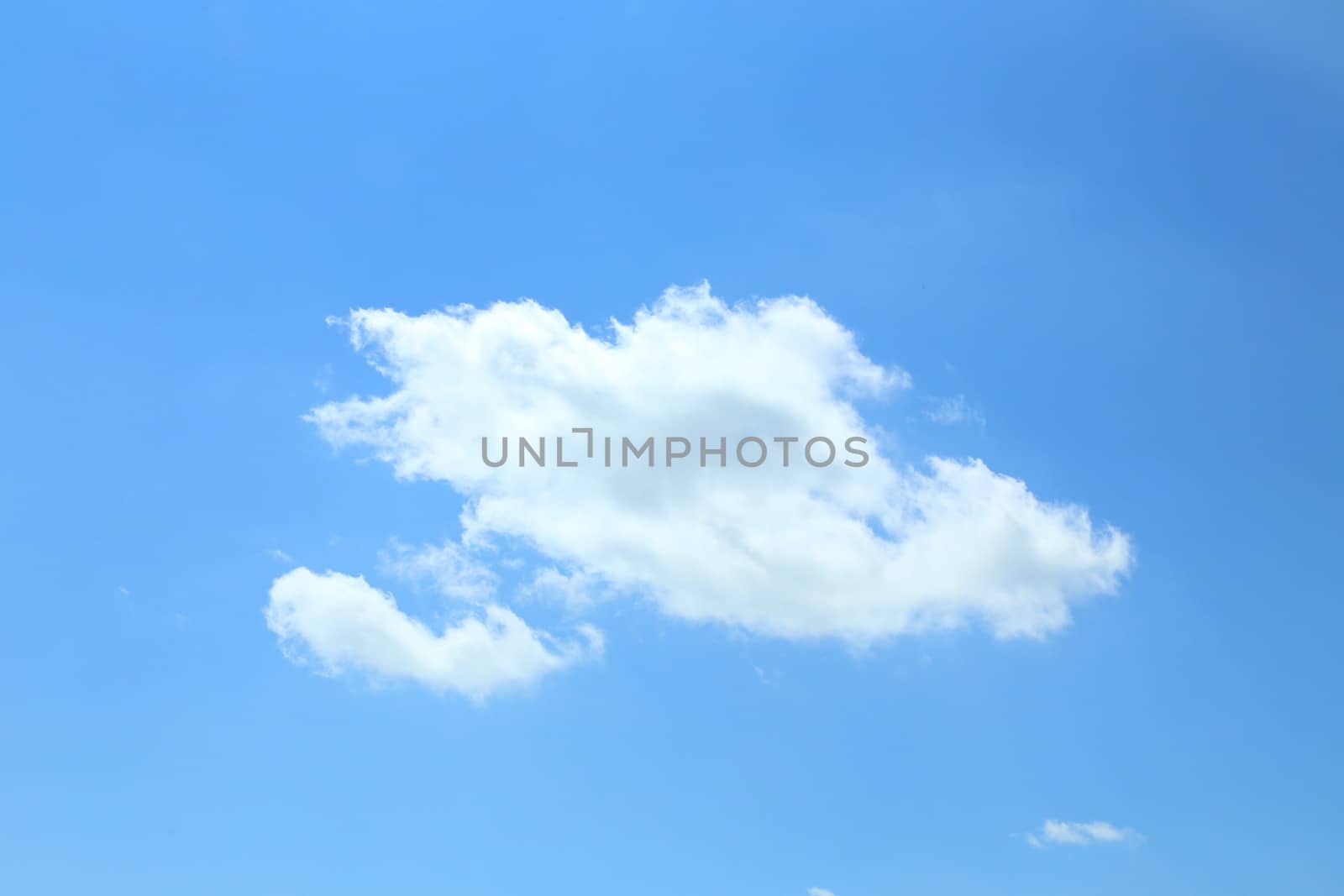 Single cumulus cloud on a blue sky