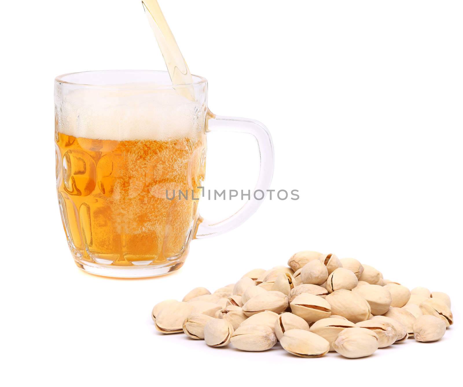 Glass of beer and pistachios on a white background