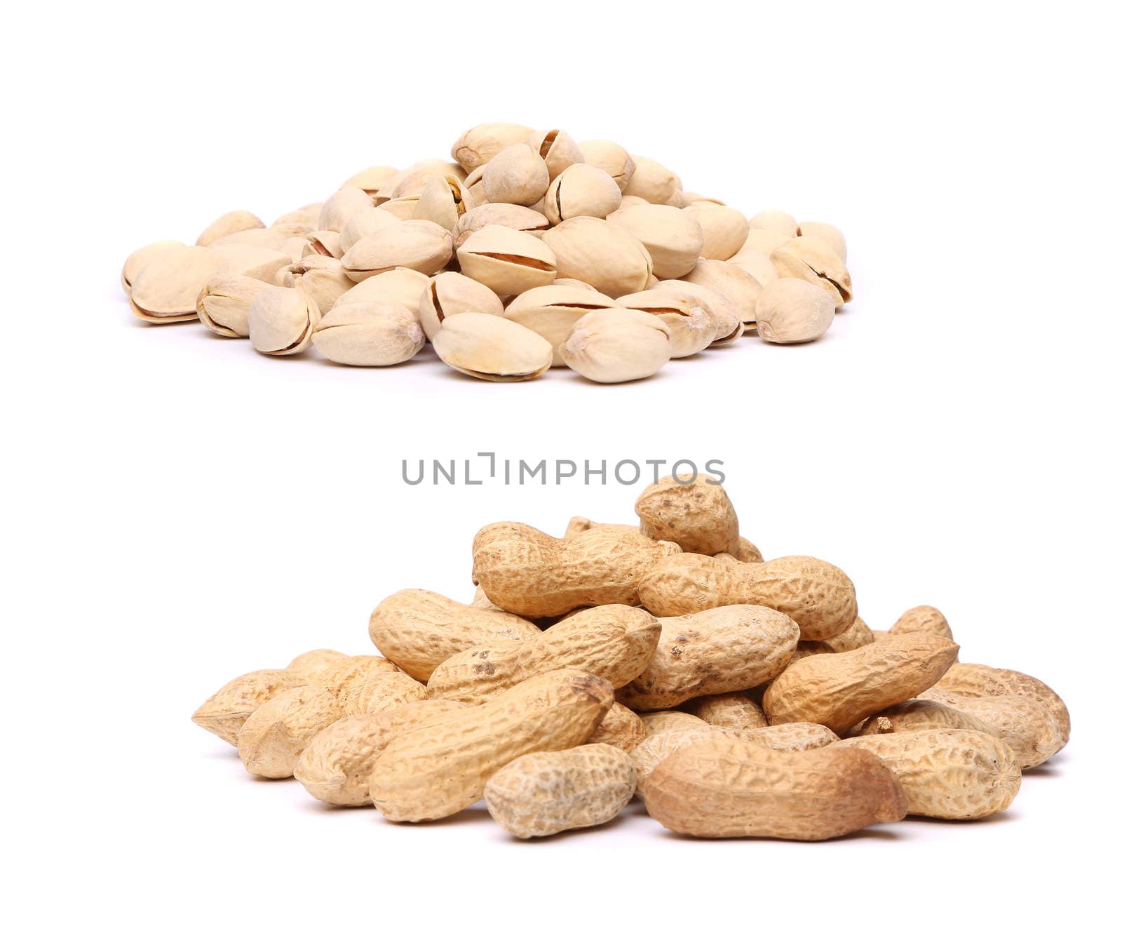 A bunch of pistachios and a bunch of peanuts on the white background.