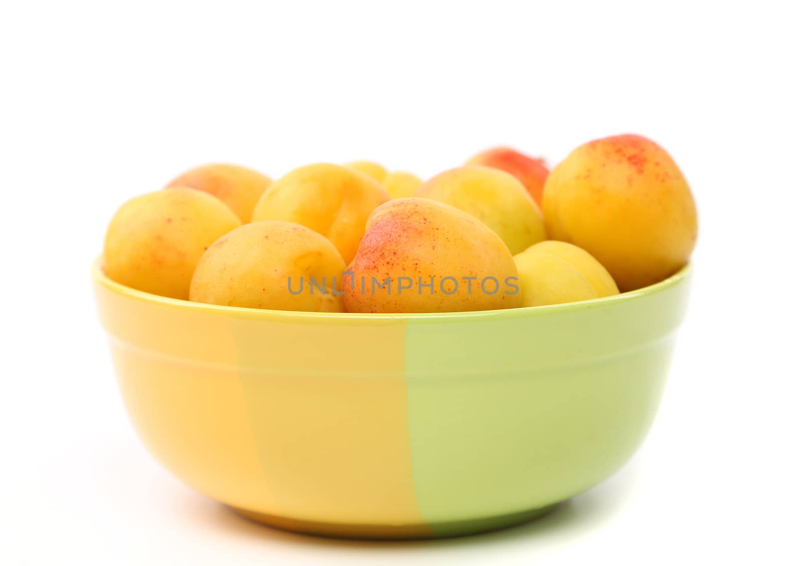 Fresh apricots in cup isolated on white