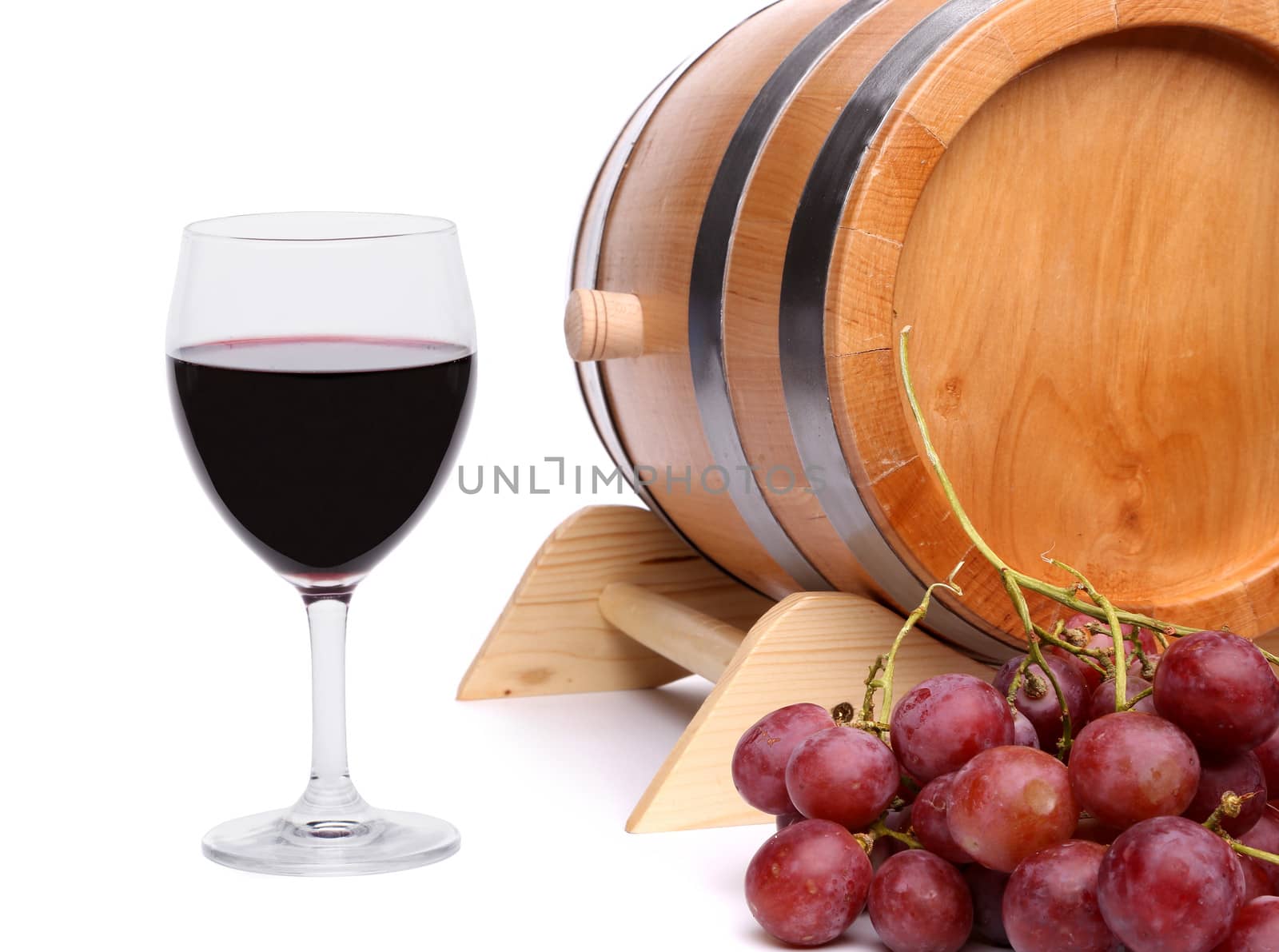 Red wine, grapes and old barrel on white background