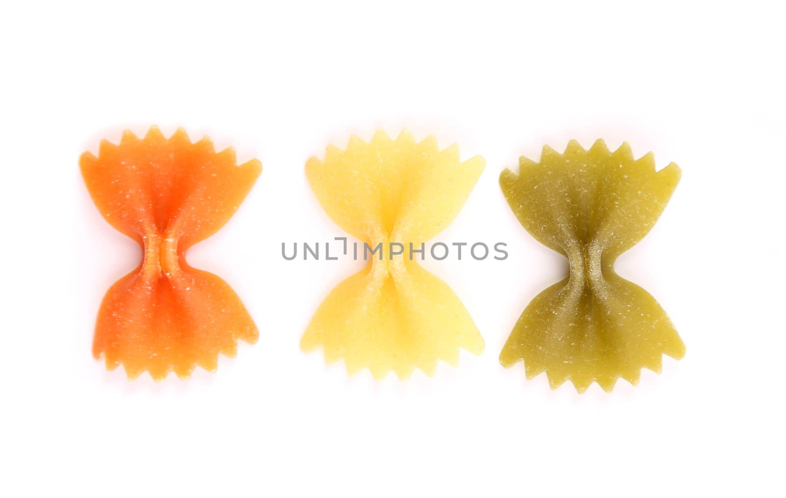 Farfalle pasta, isolated, three colors on a white background.