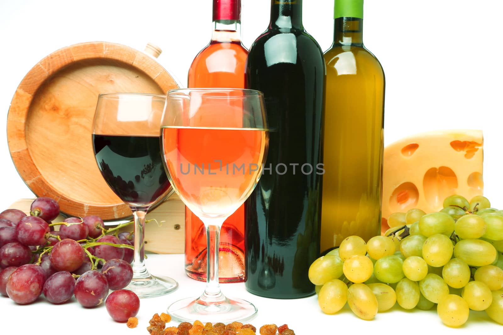 barrel, cheeses, bottles and glasses of wine and ripe grapes