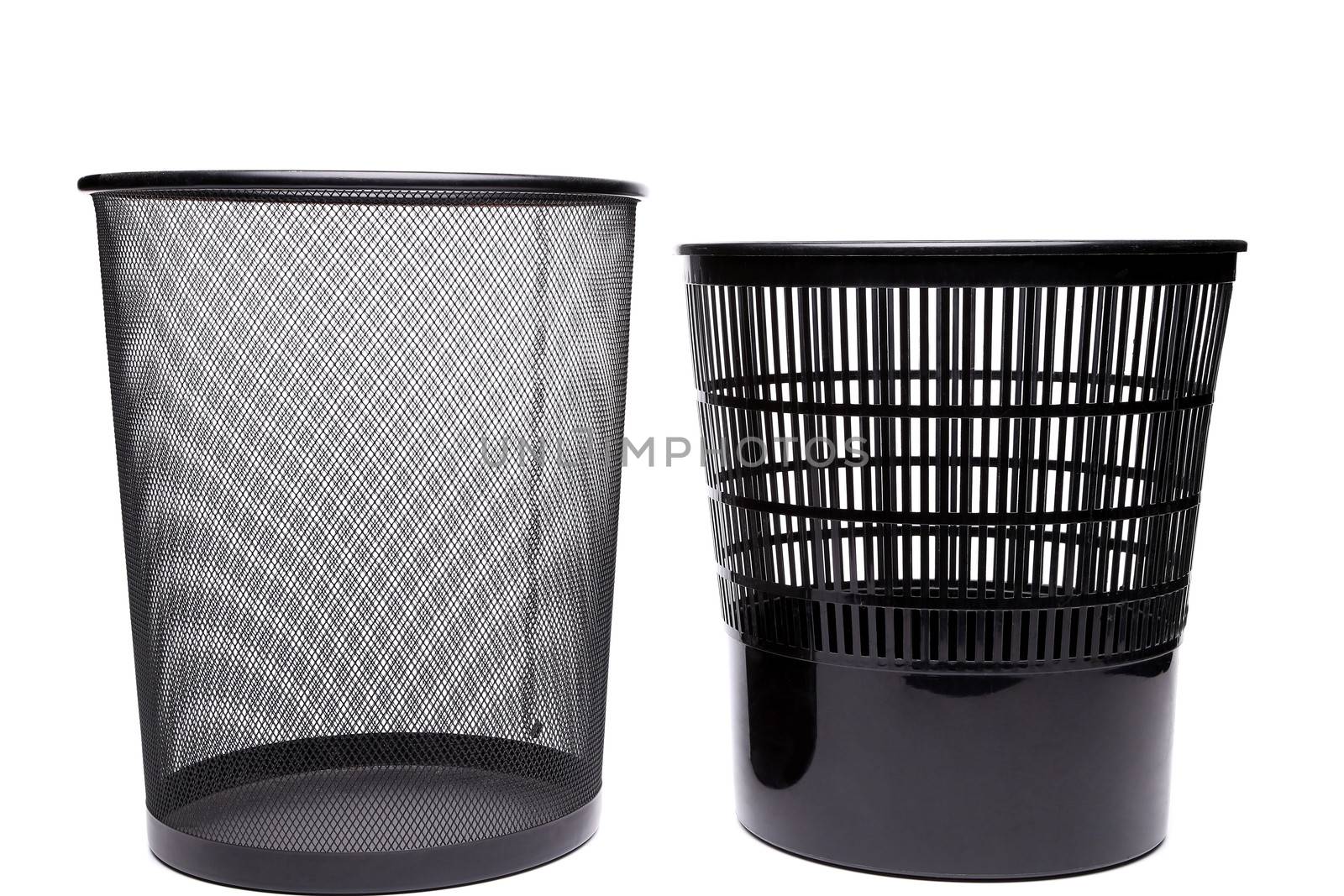 Metal and plastic trash cans on white background
