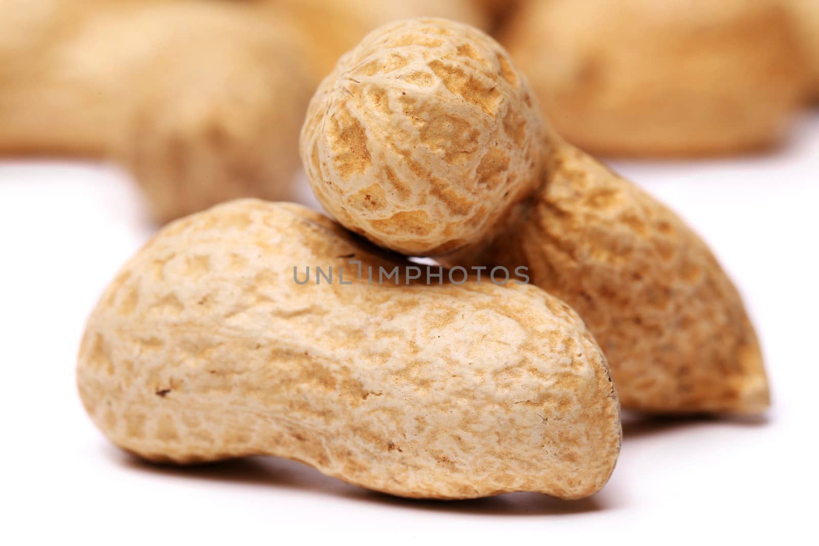 close-up of some peanuts on a background of other peanuts