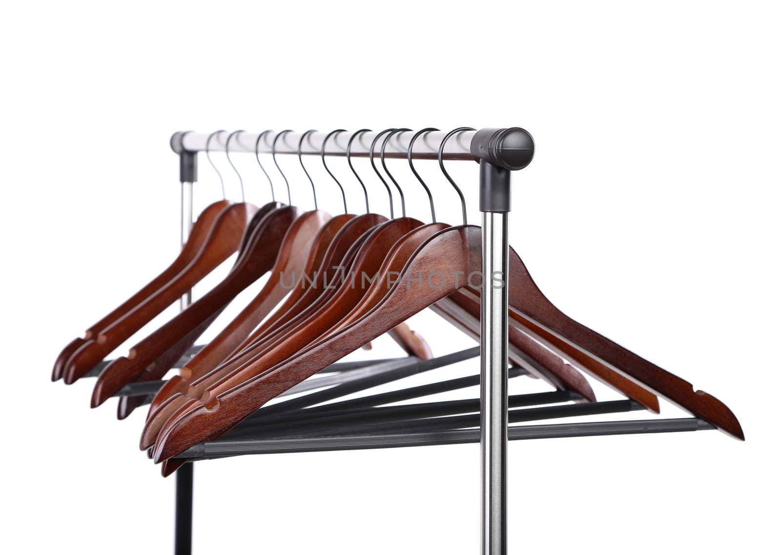 Many wooden hangers on a rod, isolated on white background