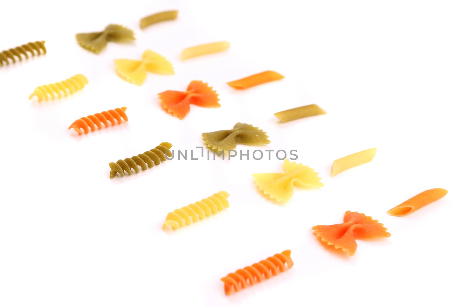 crossover from different color pasta on a white backgroun