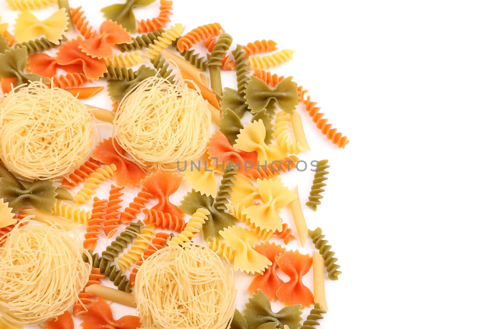 A different pasta in three colors close-up on the white background.