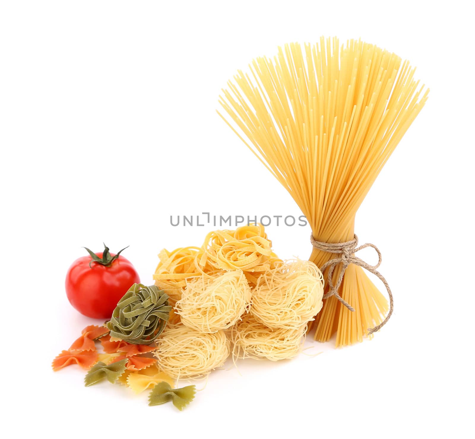 different pasta and tomato on a white background