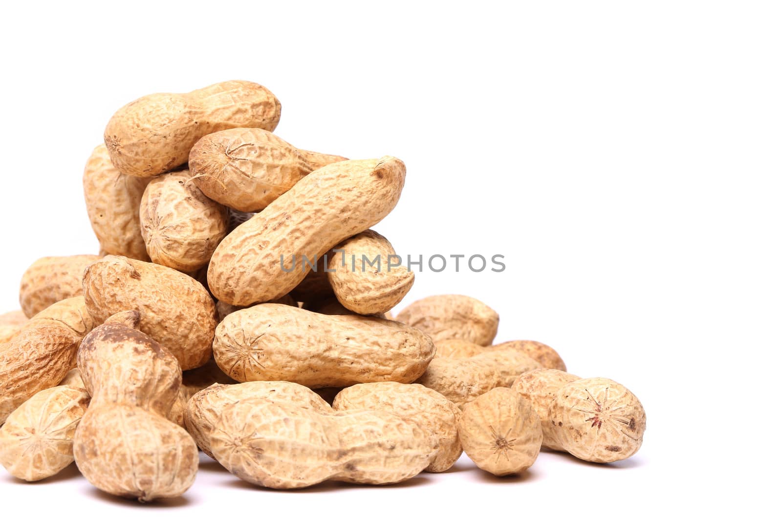 Dried peanuts in closeup on a white background
