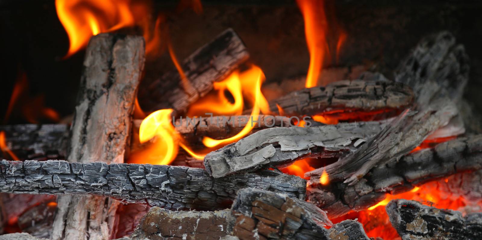 fireplace with coals burning down. whole background