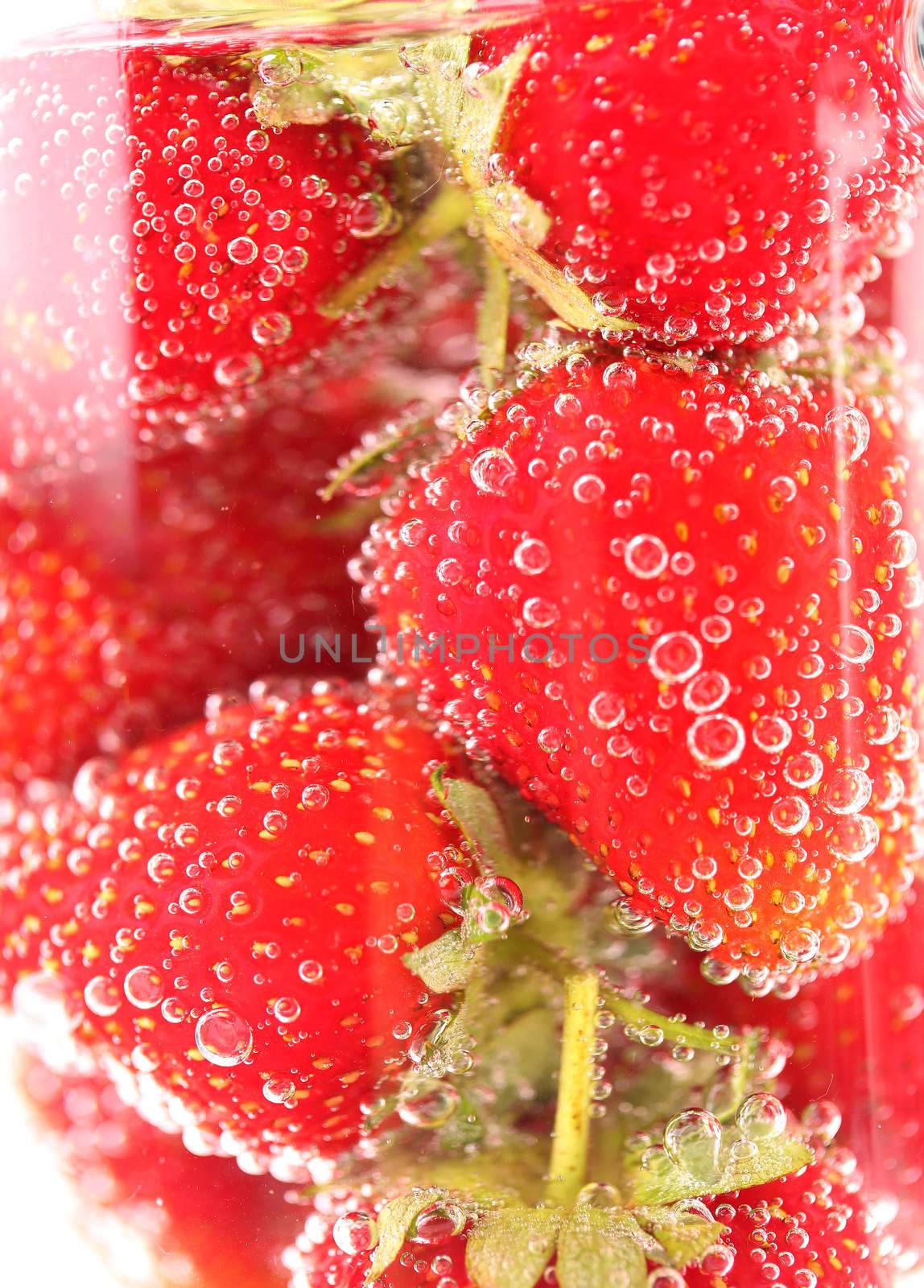 Sparkling wine (champagne) and strawberry on a white background