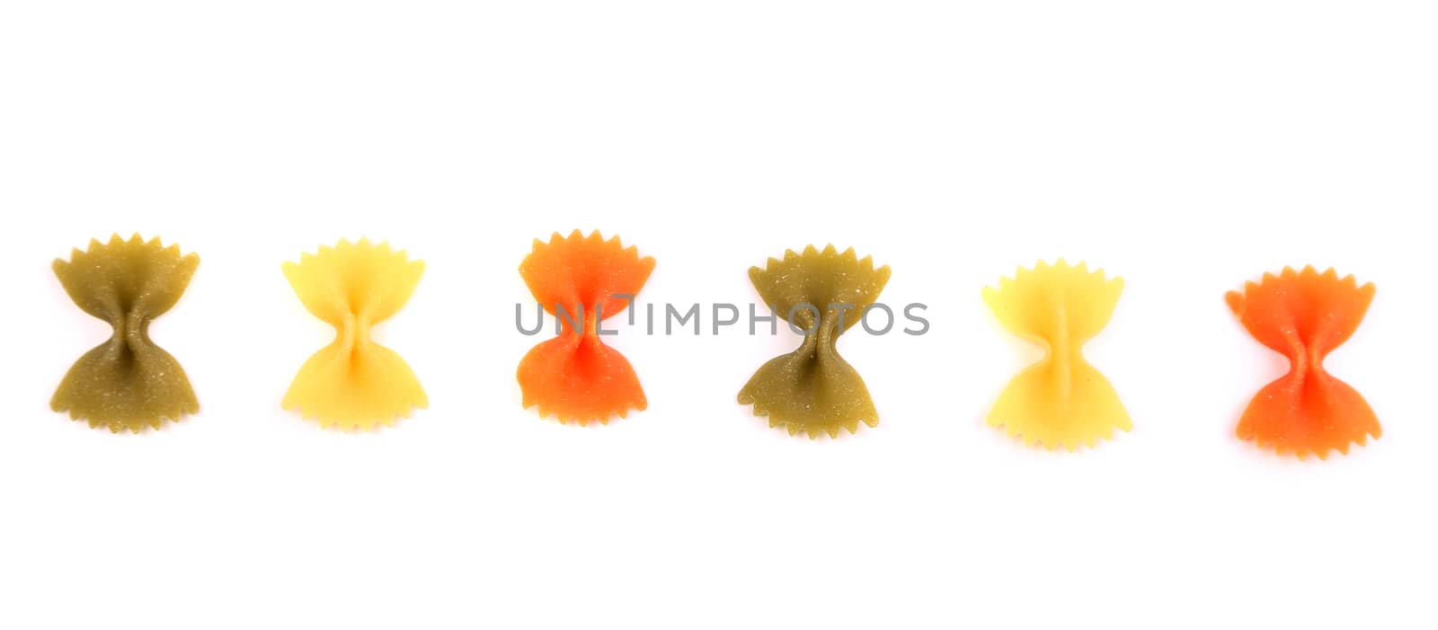 Pasta farfalle three colors are located on the white background.