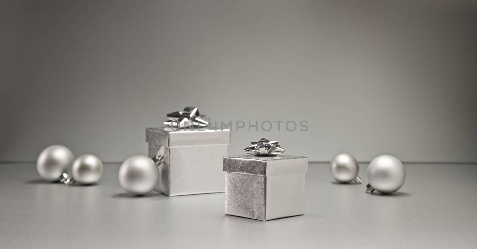 Silver bauble and present in Christmas setting