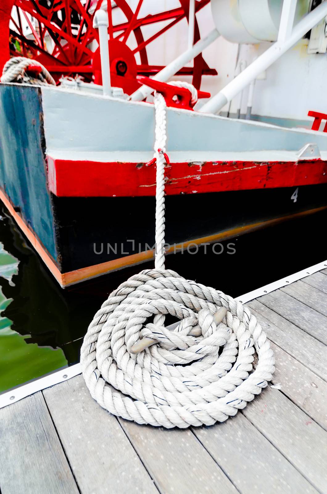 Closeup of boat tied to dock.