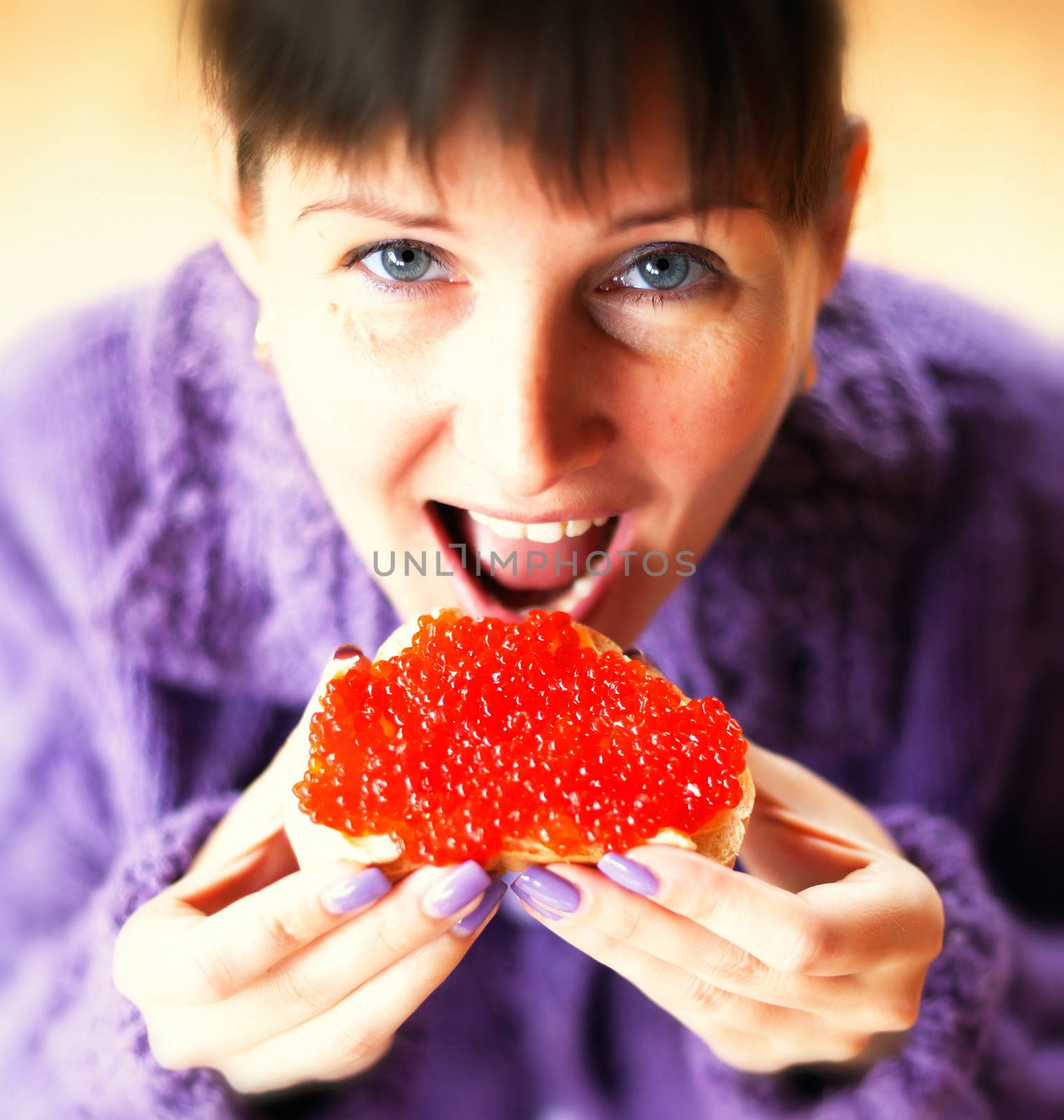  Woman eating the sandwich with red caviar  by vladimir_sklyarov