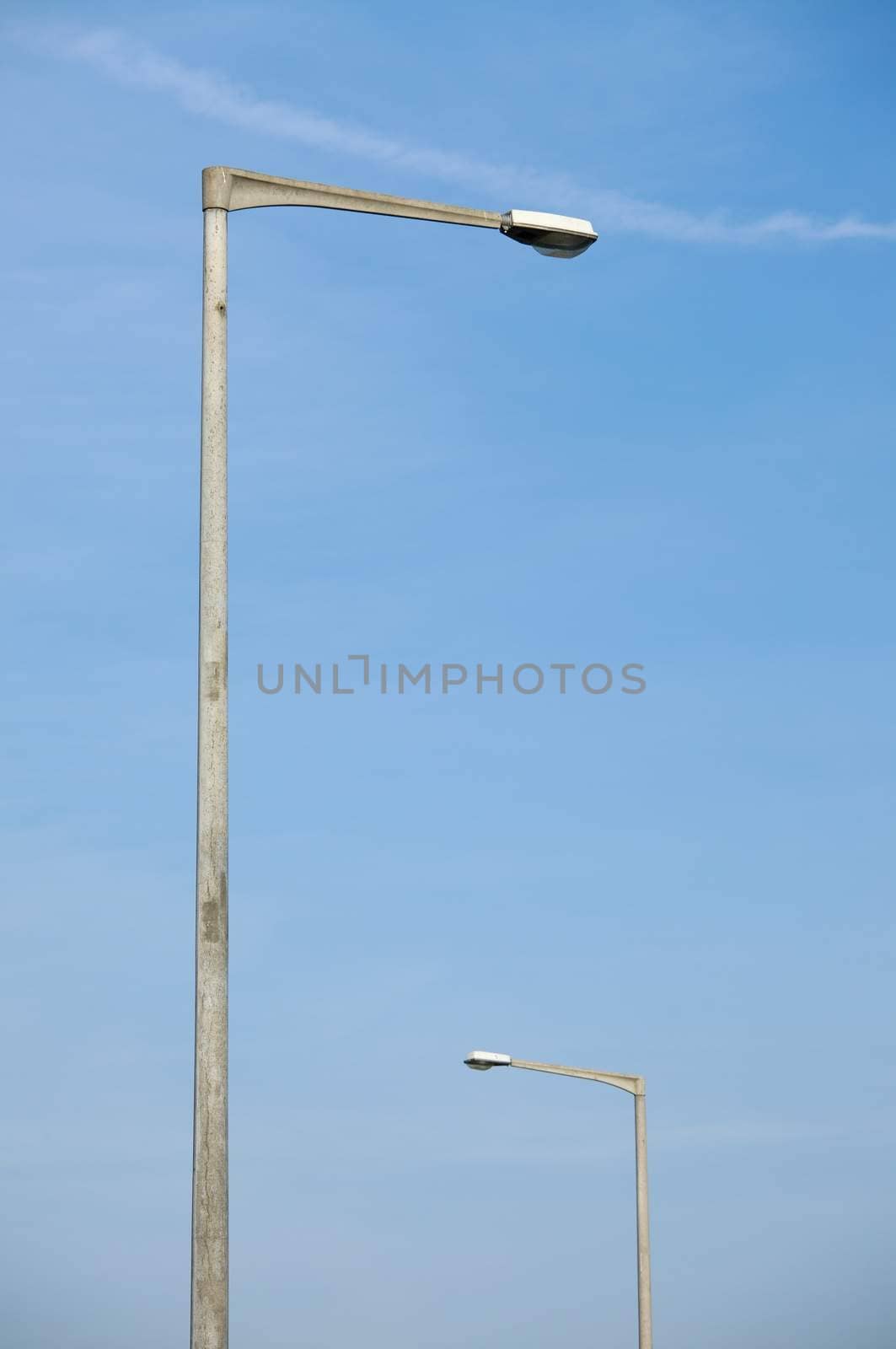 Street lamps against blue sky