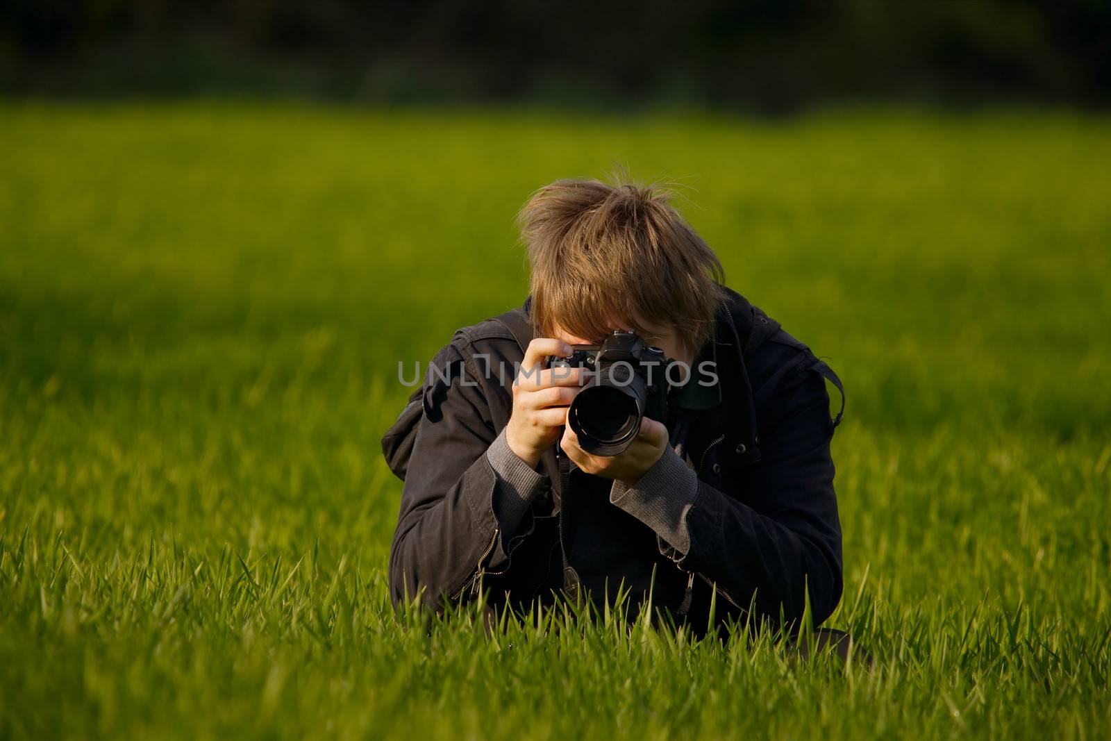 Photographer shooting on a field