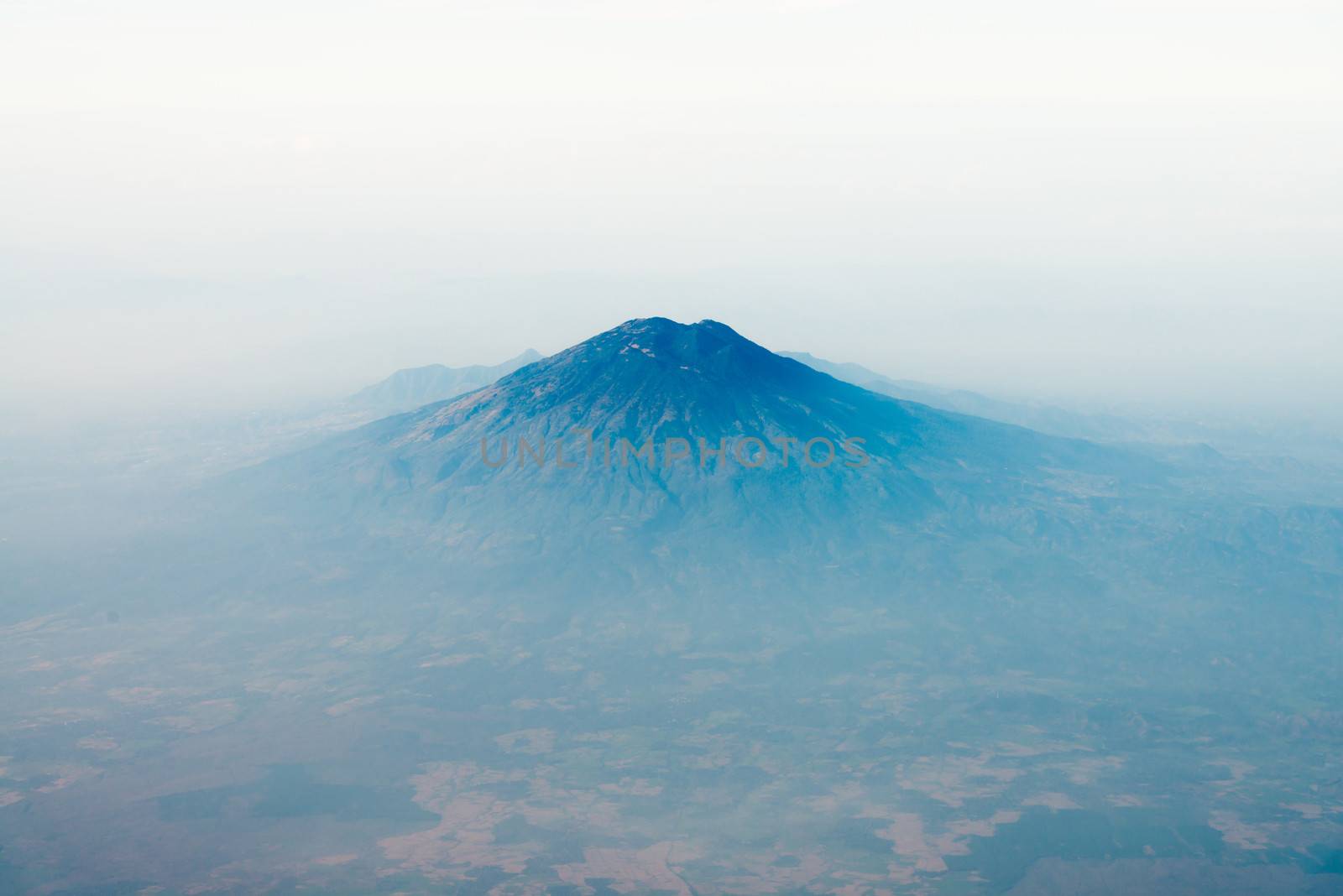 Volcano top under sky with foggy valley, bird's eye view. Java island, Indonesia