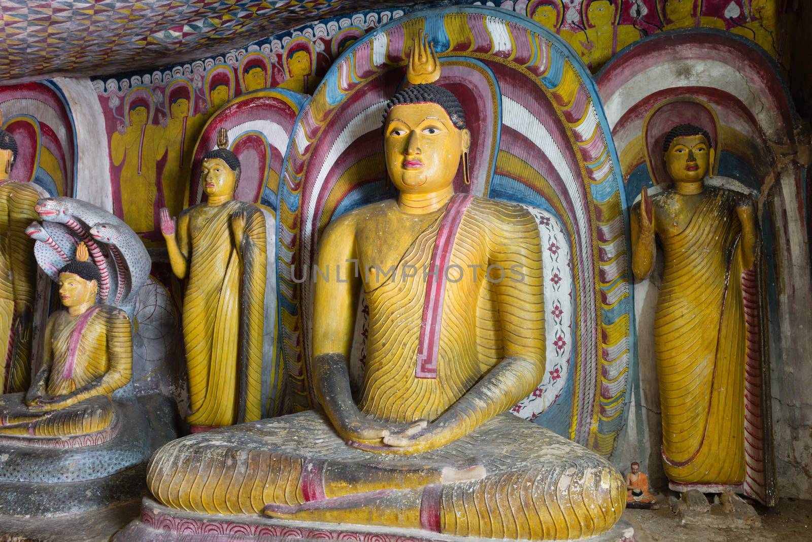 Sitting and standing Buddha statues in Dambulla Cave Temple, Sri Lanka