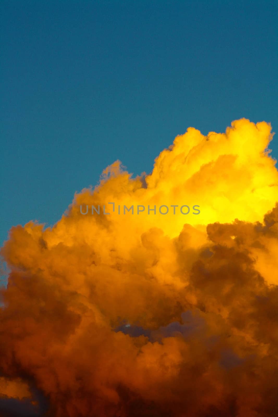 Golden clouds on blue background formatted as portrait